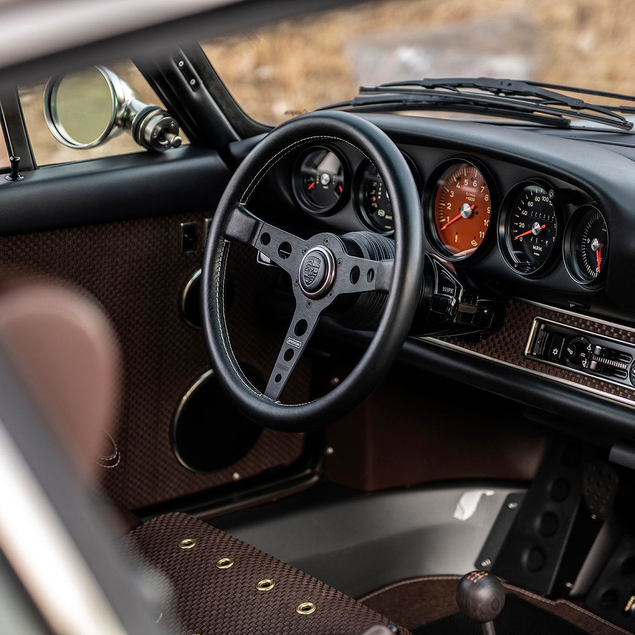 Perfectly detailed luxury sports car interior — steering wheel and instruments